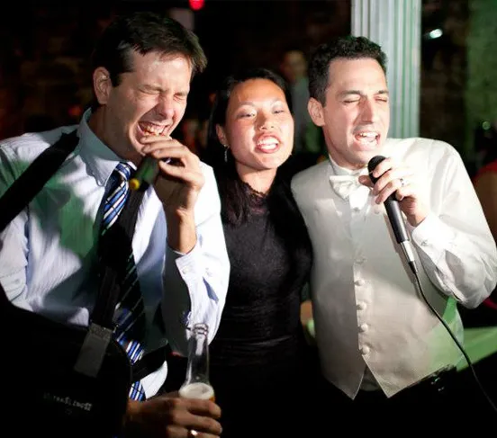 Guests participating in karaoke at an Icon DJ event