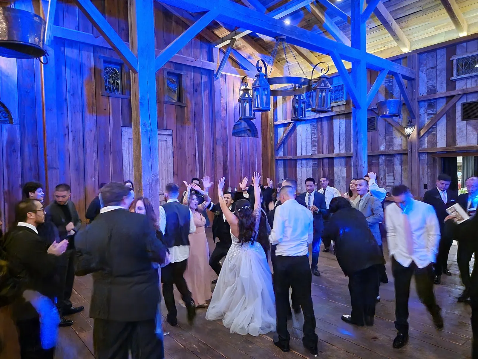 Guests dancing in a timber barn
