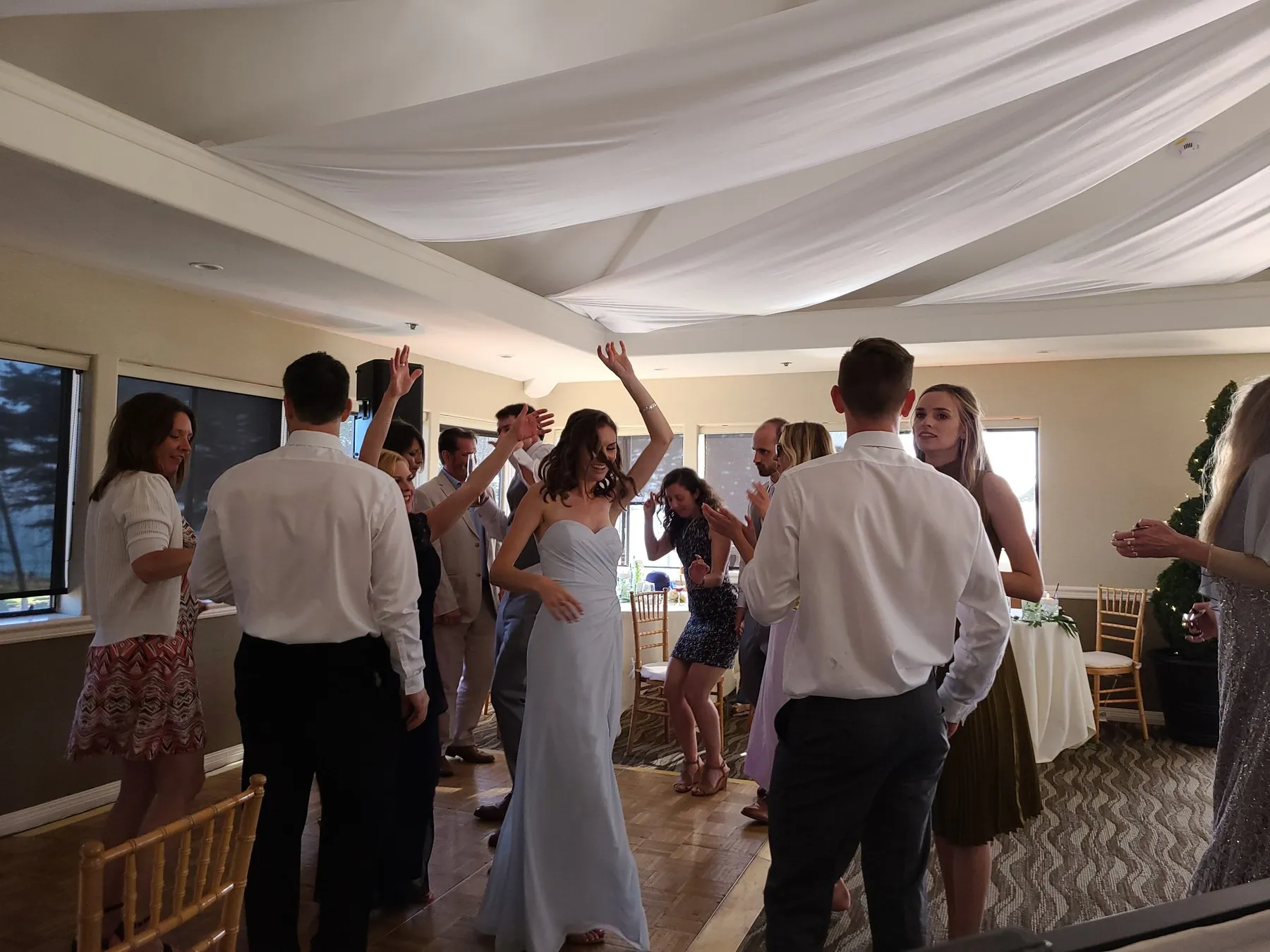 Bride dancing with guests at her reception