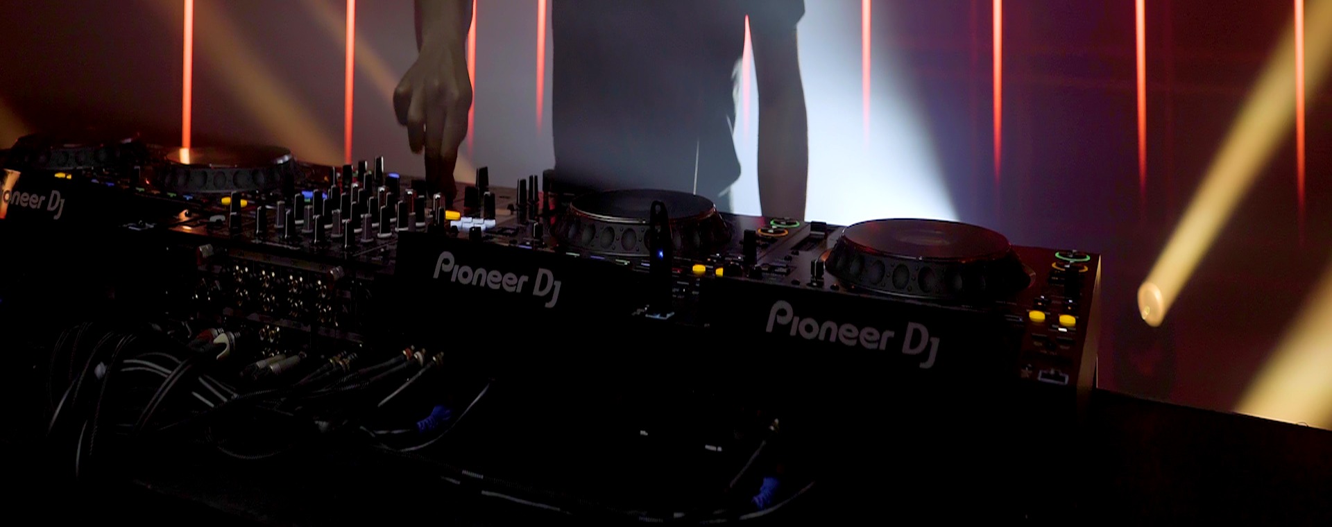 Pioneer DJ players and mixer in a professional event booth
